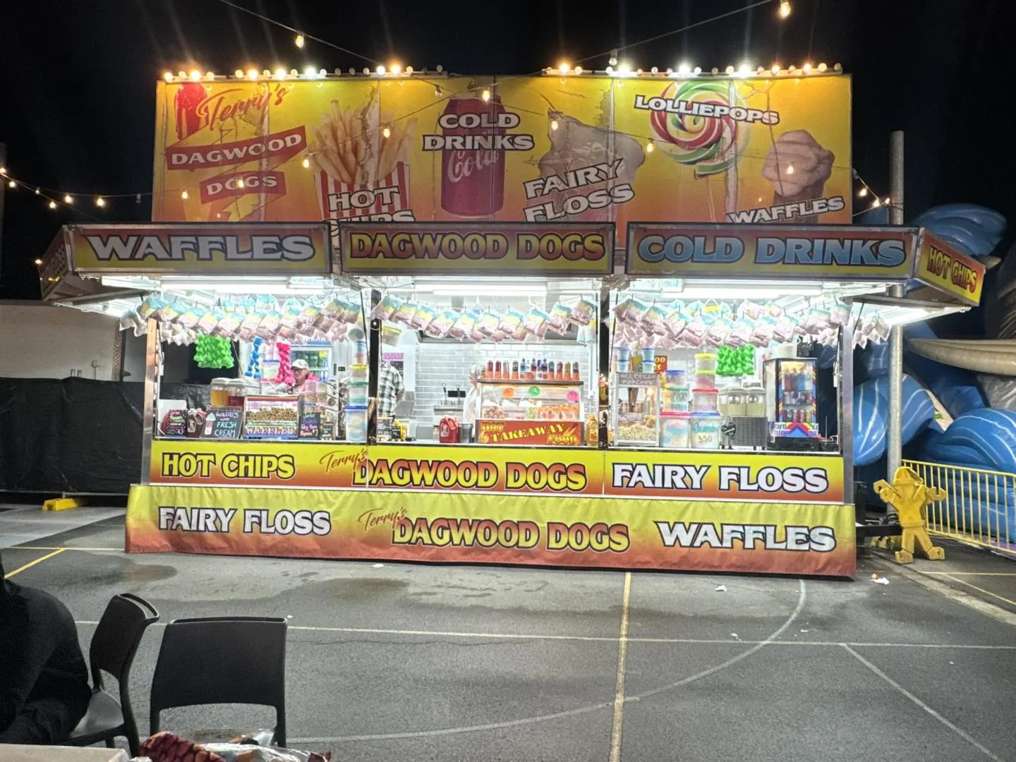 Carnival food stall with festoon lights at night